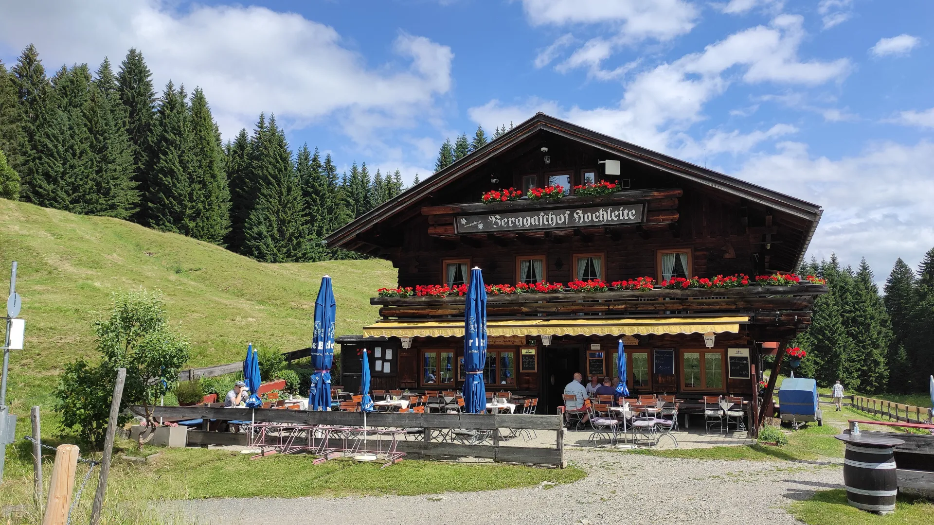 Mountain inn with flower-decked balconies and a sun terrace at the edge of the forest
